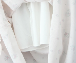 Close-up of floral print fabric with lace detail and high-quality white inner lining
