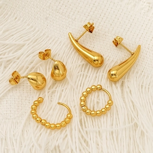 Three pairs of vintage gold chunky hoop and bead earrings in polished metal finish