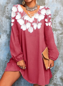 Detail of V-neckline with white floral print on a long-sleeve mauve pink dress