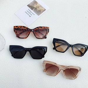 Retro small cat eye sunglasses collection in black and tortoise on white texture