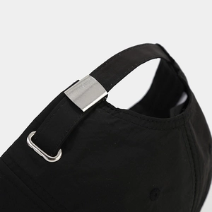 Detail of adjustable metal buckle and breathable fabric on the back of the black cap