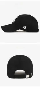 Detail view of adjustable metal buckle strap and white embroidery on a black baseball cap