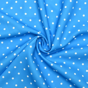 Macro detail of soft blue fabric with white polka dots for stylish summer dresses