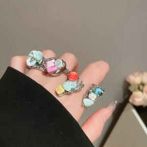 Close-up of colorful flower rings set with vibrant resin inlay on silver bands