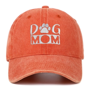 Detail of Dog Mom white embroidery and paw print on orange washed cotton baseball cap
