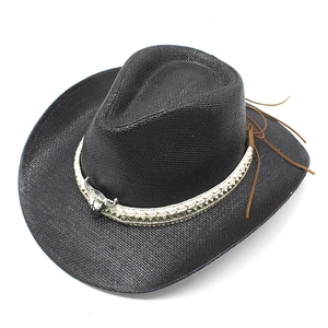 Close-up of black straw cowboy hat with silver bull head ornament and braided band