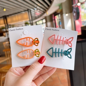Close-up of cute carrot and fishbone hair clips for girls on classic product cards