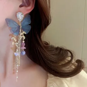 Elegant long fringe earrings with blue butterfly wings and sparkling crystal tassels