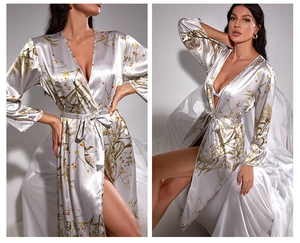 Detailed macro view of silver silk satin fabric with elegant floral pattern and smooth texture