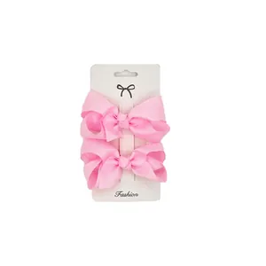 Set of 2 pink 3-inch grosgrain ribbon bow hair clips for girls on display card