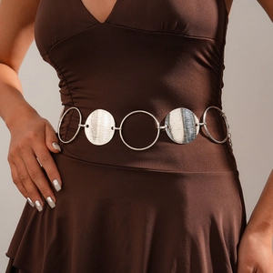 Detail of silver metallic waist chain featuring textured round discs and adjustable links