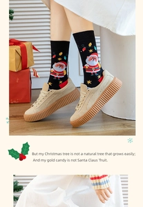 Detail of Christmas crew socks with Santa and fairy lights worn with beige sneakers
