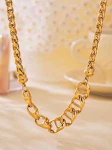 Detail of 18K gold plated pig nose chain showing woven and geometric hollow links