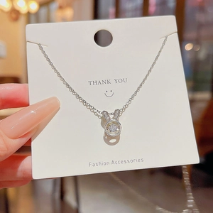 Close-up of a silver bunny pendant featuring a sparkling white dancing zircon stone