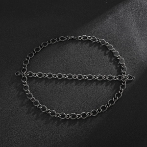 Macro shot of black punk-style stainless steel 10mm twist chain necklace on dark background
