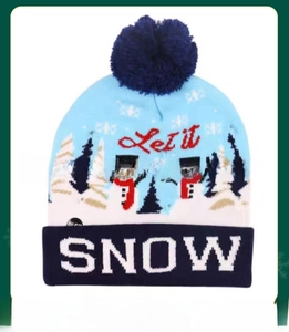 Detail of knitted winter hat with LED lights, festive snowman pattern, and SNOW text