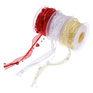 Close-up of heart patterned ribbons in red and white on transparent spools for gift wrapping