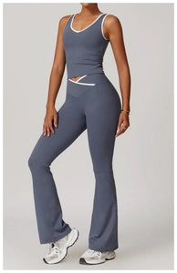Macro shot of flared yoga pants featuring a cross high-waisted design and white contrast piping
