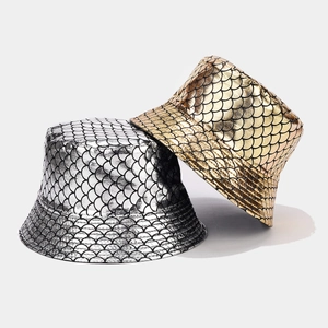 Close-up detail of metallic fish scale texture on reversible gold and silver bucket hats