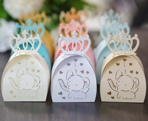 Detail view of hollow elephant candy boxes with crown tops in multiple pastel colors