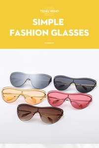 Flat lay of trendy rimless cat eye sunglasses in five vibrant colors with gold metal temples
