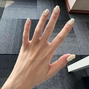 Elegant cream press-on nails with golden heart 3D charms and minimalist chic accents