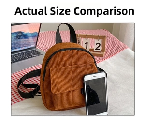 Detailed view of mini brown corduroy backpack showing compact size with a smartphone comparison