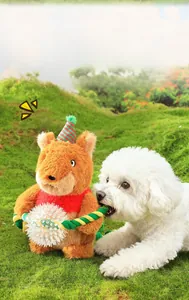 Detail of Christmas plush dog toy with squeaker and durable knotted ropes on green lawn