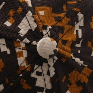 Macro shot of durable digital camouflage canvas cap crown with reinforced stitching