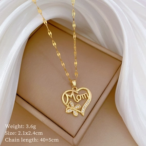 Detailed view of a gold heart pendant with Mom inscription and butterfly on water wave chain