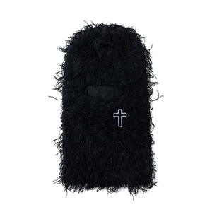 Close-up of black fuzzy balaclava featuring white cross embroidery and soft plush texture