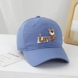 Detail of light blue cotton baseball cap with 3D cartoon bear and LUCK embroidery