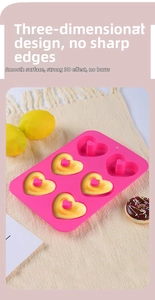 Detail of pink silicone 6-cavity heart donut mold on woven mat with lemon accents