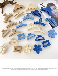 Flat lay of diverse matte resin hair claws in beige and blue on a clean white surface