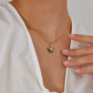 Elegant gold titanium steel necklace featuring a star pendant with abalone shell inlay