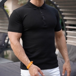 Close-up of men's slim fit black knit polo shirt showing ribbed texture and muscle fit