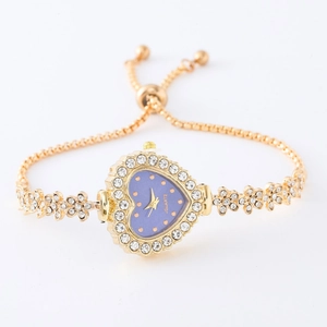 Macro detail of heart-shaped gold watch with purple dial and adjustable crystal strap