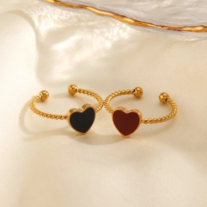 Minimalist gold twist open rings with black and red enamel heart charms on silk