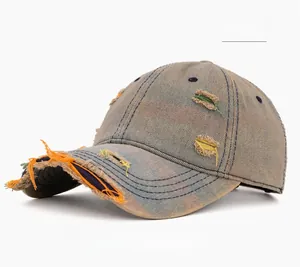 Close-up of distressed denim baseball cap with colorful stitching and ripped details