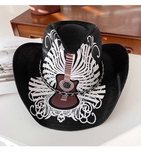 Détail d'un chapeau de cow-boy noir avec motif guitare, volutes et chaîne métallique