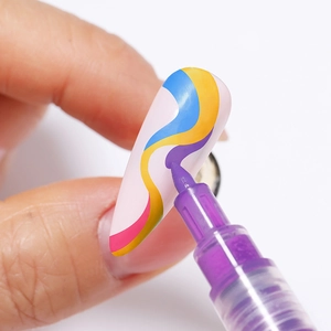 Macro shot of purple nail art pen drawing colorful wavy patterns on a white nail tip