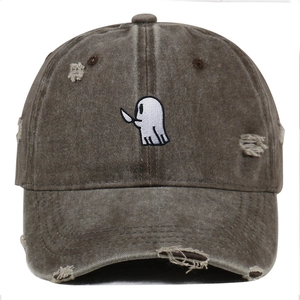 Close-up of cute ghost embroidery and distressed ripped details on cotton baseball cap
