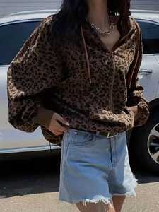 Detail of leopard print hoodie with corduroy texture and metallic zipper closure