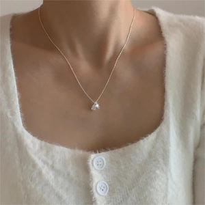 Elegant 925 sterling silver necklace with teardrop zircon pendant worn on a sweater