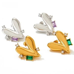 Detailed macro view of heart-shaped titanium steel earrings with inlaid gemstones