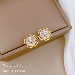 Detail shot of gold flower earrings with crystals on jewelry box, 1.4x2cm, weight 3.3g