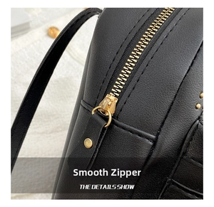 Detailed macro view of smooth gold zipper and premium black leather texture on backpack
