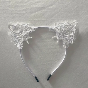 Elegant white lace cat ear headband for women with intricate hollow floral design
