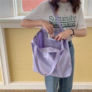 Detail of purple canvas tote bag interior showing large capacity and snap button closure
