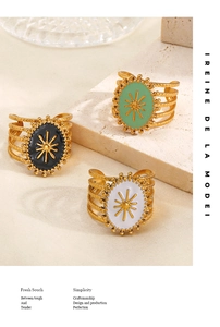 Detailed view of three vintage-style resin drip gold-plated rings with sunburst star motifs